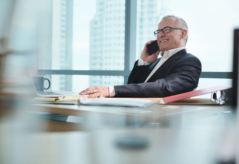 Relaxed smiling businessman on phone with full managed it services