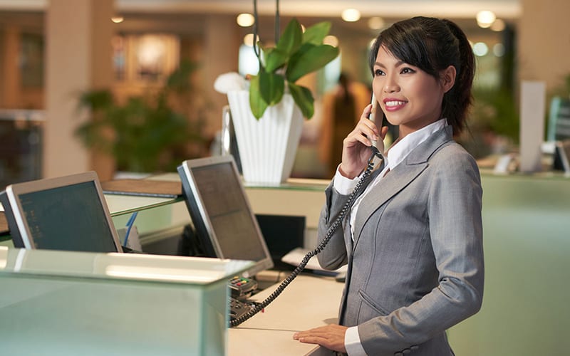Smiling Concierge Answering Phone Hospitality