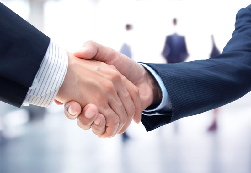 Businessmen shaking hands merger acquisition