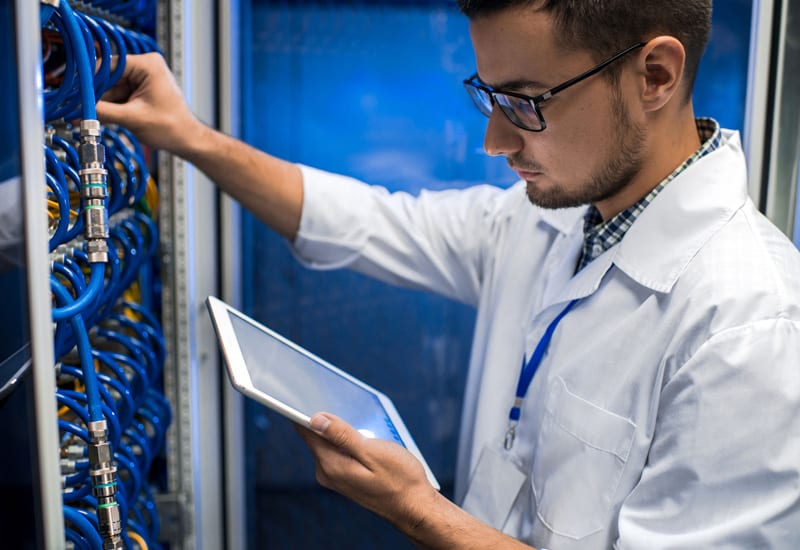 IT Service Capabilities: Network Engineer working in data center rack